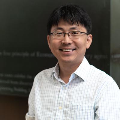 Assistant Professor Seung Hoon Lee professional headshot in front of chalkboard
