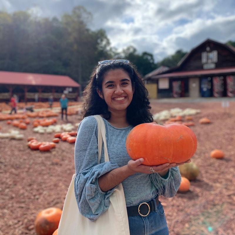 Rupkatha posing with a pumpkin at a farm