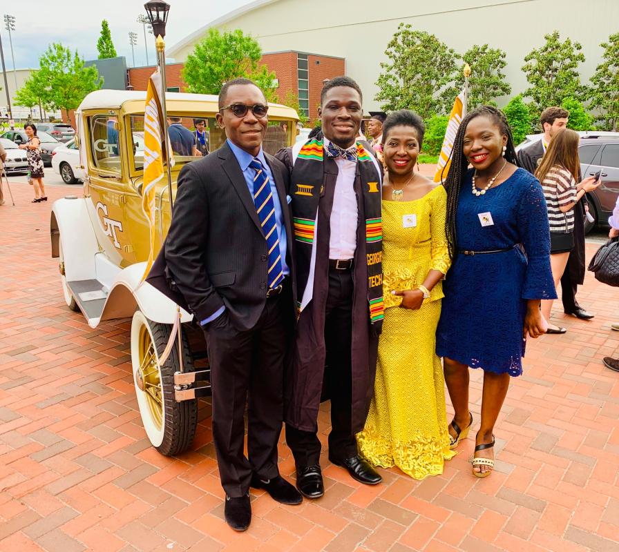Ayo with his family in front of the Ramblin' Wreck on graduation day
