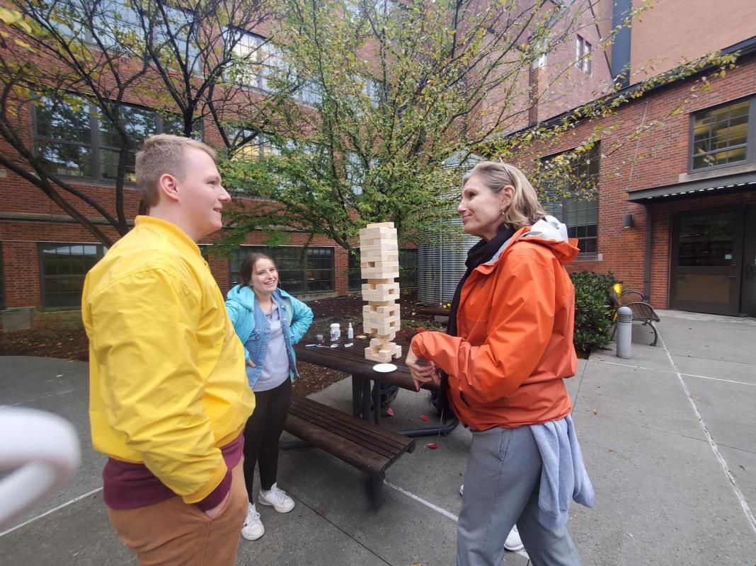 Laura posing with the Econ students playing giant Jenga